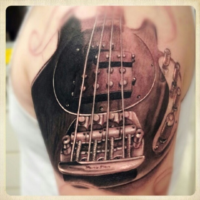 Music tattoo: bass and treble clefts with the musical phrase 